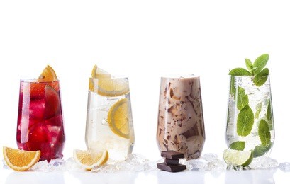 delicious refreshing summer drinks . sangria , lemonade, iced chocolate drink , a mojito on a white background . ice cubes around glasses with drinks . natural collage of beverages