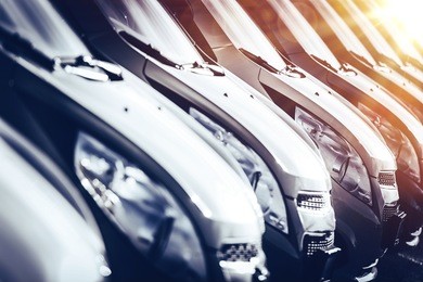 cars in stock closeup. row of brand new cars for sale. new cars industry.