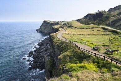 view of olle no. 10 course in songaksan in jeju island, korea. olle is famous trekking courses created along coast of jeju island. songaksan is famous place for drama "all-in" filming location.