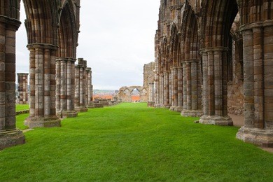 famous whitby abbey in england.whitby abbey is a ruined benedictine abbey overlooking the north sea on the east cliff above whitby in north yorkshire, england.