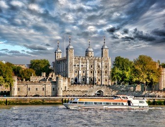 london with tower hill old castle against boat in  england, uk