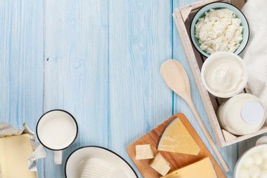 dairy products on wooden table. sour cream, milk, cheese, egg, yogurt and butter. top view with copy space