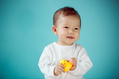 baby playing rubber duck in the blue bedroom, baby healthy and preschool concept