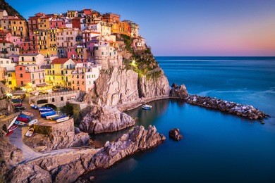 manarola, liguria, italy. the wonderful manarola village as you can see it from the mountain above. quiet sky and peaceful sea, during sunset.