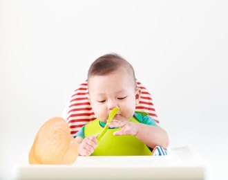 baby child eating in chair