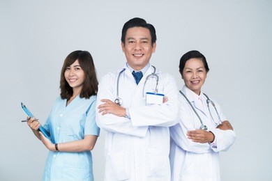 group of smiling asian medical workers with leader in front