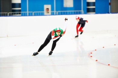 speed skating young female sportsman during competition race 