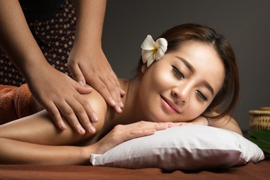 asian woman having massage and spa salon beauty treatment concept. she is very relaxed
