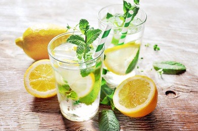 refreshing iced mint tea with lemon and ice cubes, a drink for hot summer days selective focus, toned image