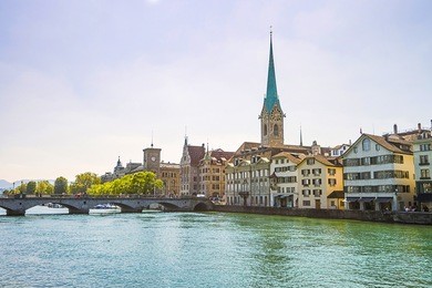 zurich city center and limmat quay in summer with city hall clock tower spire