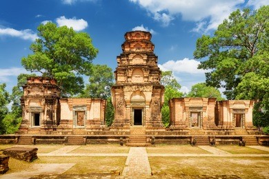 prasat kravan temple is khmer monument in ancient temple complex angkor wat on sunny day in siem reap, cambodia. woods and blue sky in background. angkor wat is a popular tourist attraction.