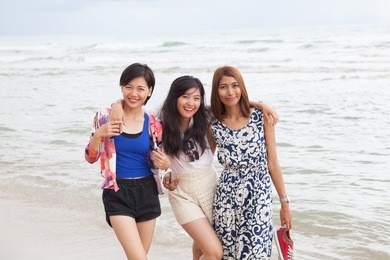 portrait of young asian woman friend relaxing  at sea beach