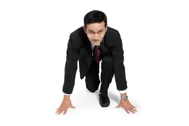 young asian businessman in steady position to run toward camera, isolated on white background
