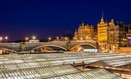 view of the city centre of edinburgh and the roof of waverley railway station