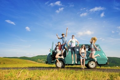 young hipster friends on road trip on a summers day