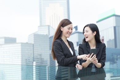 asian business women talking to each other in hong kong, asia.