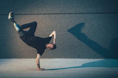 bboy doing handstand on street