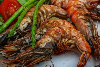 grilled tiger prawn with asparagus and salad leaves