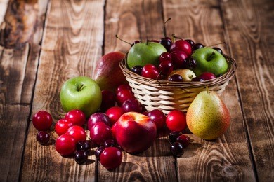 fruit in a basket on a wooden background