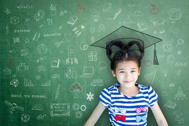 smart educated school kid student with graduation hat doodle on chalkboard  for children's world literacy day and scholarship concept