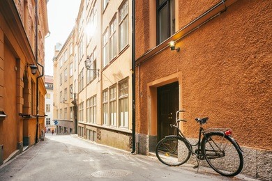 parked bicycle on sidewalk in old european town. bike parking on street, stockholm, sweden