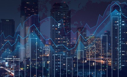 trading graph on the cityscape at night and world map background,business financial concept