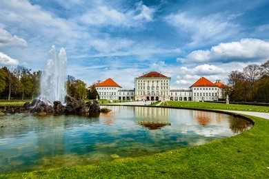 fountain in grand parterre (baroque garden) and the rear view of the nymphenburg palace. munich, bavaria, germany