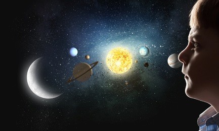 cute boy of school age exploring space system