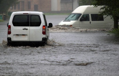 car rides in heavy rain on a flooded road