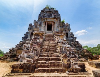 stairs leading to top of temple-mountain of ancient ta keo. amazing angkor, siem reap, cambodia. blue sky in background. mysterious angkor is a popular tourist attraction.