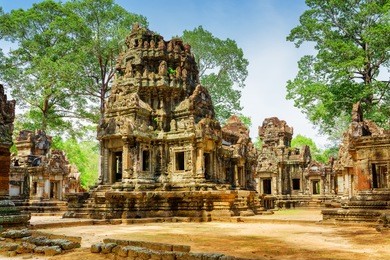 ancient buildings of thommanon temple in enigmatic angkor, siem reap, cambodia. mysterious thommanon nestled among rainforest. blue sky in background. amazing angkor is a popular tourist attraction.