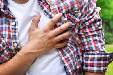 man having chest pain - heart attack, outdoors