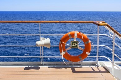 orange life buoy on the deck of a cruise ship.