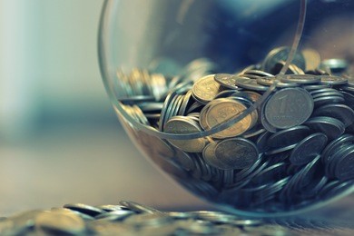 coins in a piggy bank vase