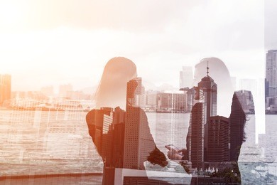 silhouette of two businesswomen stand and look far away in hong kong, asia. double exposure.