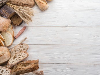 the bread and a wheat on the wooden desk.