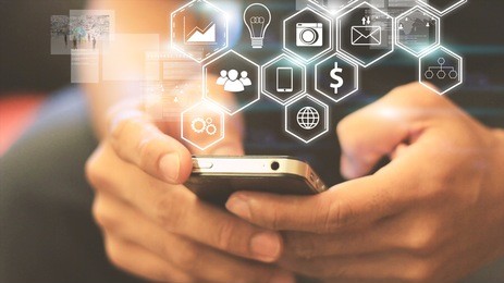 hipster using a touch screen smart phone.cross process