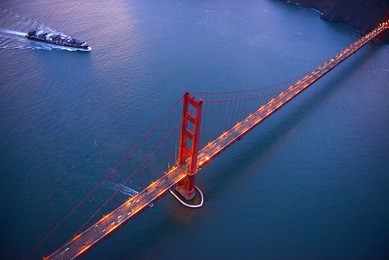 an aerial view of golden gate bridge in san francisco during sunset, taken from a helicopter