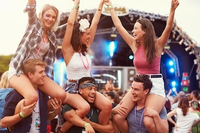 friends having fun in the crowd at a music festival