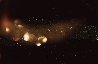 glitter vintage lights background. dark gold and black. defocused
