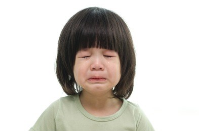 close up of cute asian baby crying on white background isolated