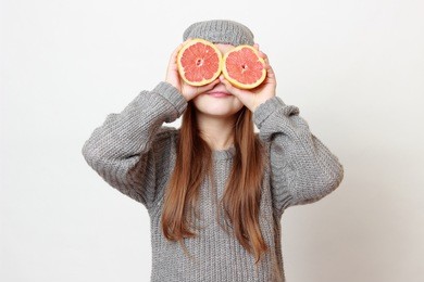 fashion little girl holding grapefruit