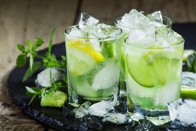 lemon-lime green drink with crushed ice on a dark background, selective focus