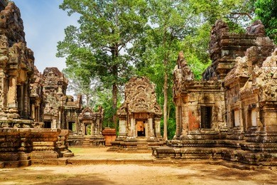 ancient buildings of thommanon temple in amazing angkor, siem reap, cambodia. mysterious thommanon nestled among rainforest. blue sky in background. enigmatic angkor is a popular tourist attraction.