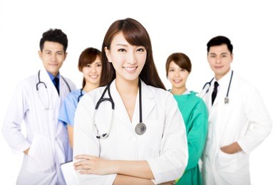 smiling medical team standing together isolated on white