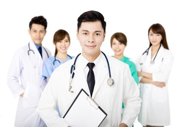 smiling medical team standing together isolated on white
