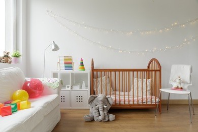 photo of white and cosy newborn room interior
