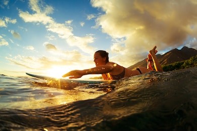 surfing at sunset. outdoor active lifestyle.