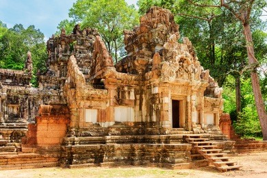 entrance to ancient thommanon temple in amazing angkor, siem reap, cambodia. mysterious thommanon nestled among rainforest. blue sky in background. angkor is a popular tourist attraction.