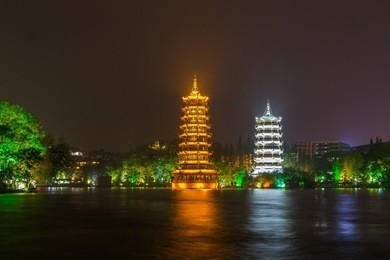 sun and moon twin pagodas at night in guilin, china